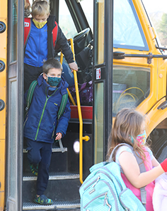 Kids walking off school bus