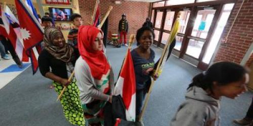 students carrying flags from different countries