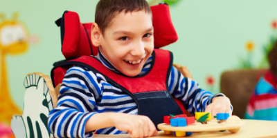 boy in a wheelchair with a shape puzzle